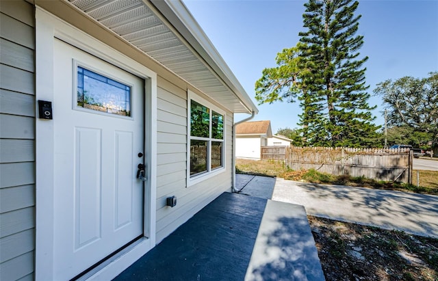 view of exterior entry with fence