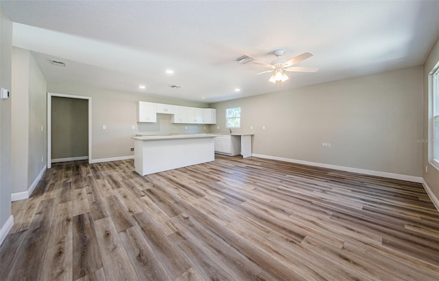 unfurnished living room featuring recessed lighting, baseboards, ceiling fan, and light wood finished floors