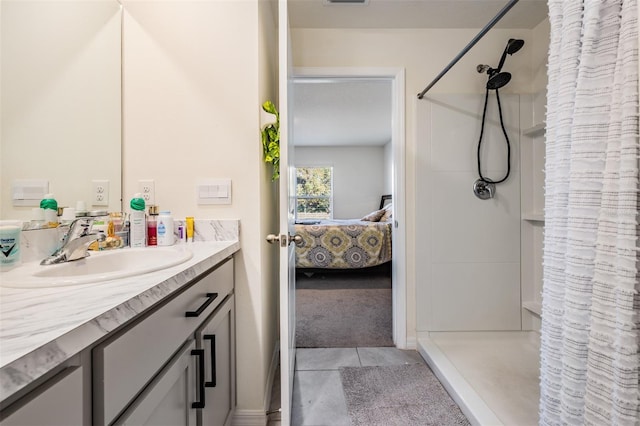 bathroom featuring tile patterned floors, a shower with curtain, and vanity