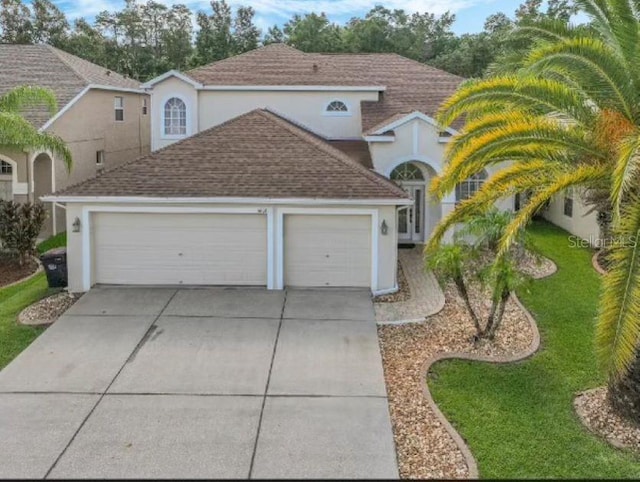 view of front of house with a front yard and a garage