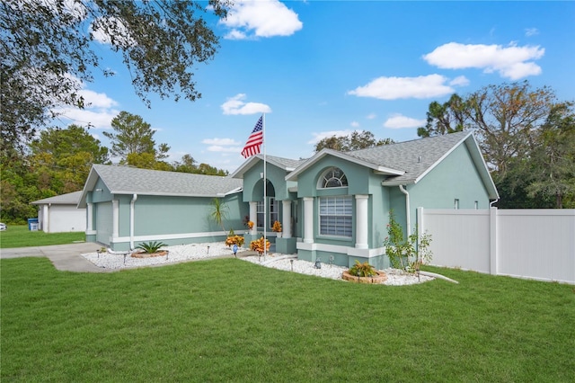 ranch-style house featuring a garage and a front yard