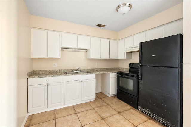 kitchen with white cabinetry, sink, light tile patterned floors, black appliances, and custom range hood