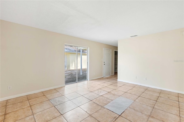 unfurnished room featuring light tile patterned flooring