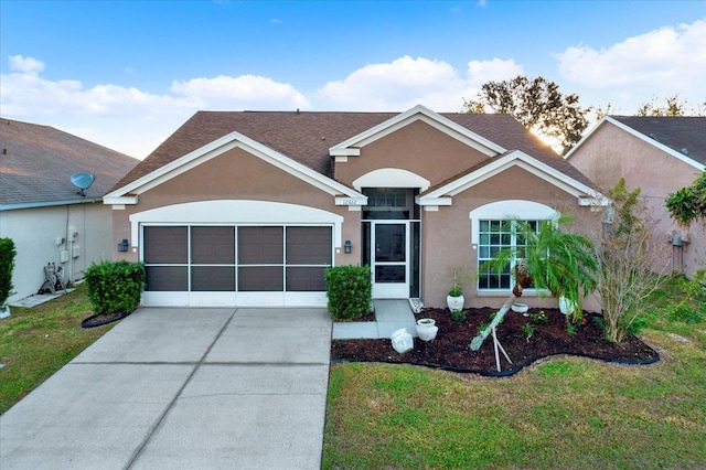 12612 Midpointe Dr, Riverview, FL 33579 - ranch-style home with a garage, stucco siding, driveway, a front yard, and roof with shingles