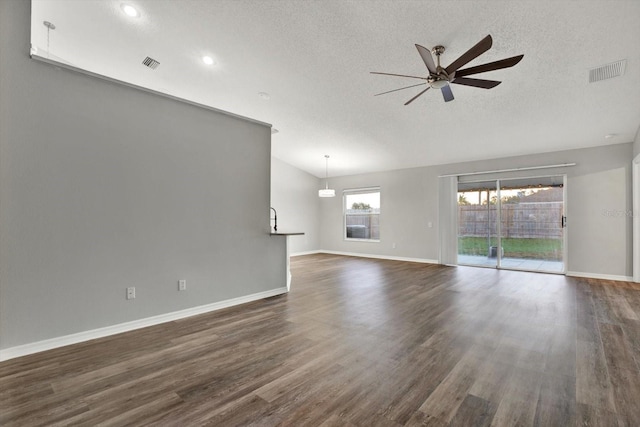 12612 Midpointe Dr, Riverview, FL 33579 - unfurnished living room with ceiling fan, a textured ceiling, baseboards, dark wood-style flooring, and recessed lighting