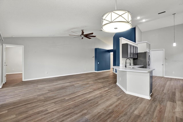 12612 Midpointe Dr, Riverview, FL 33579 - kitchen featuring stainless steel fridge with ice dispenser, open floor plan, ceiling fan, high vaulted ceiling, and light countertops