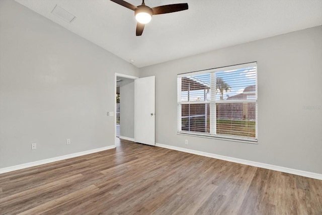 12612 Midpointe Dr, Riverview, FL 33579 - unfurnished room featuring wood finished floors, a ceiling fan, baseboards, and vaulted ceiling