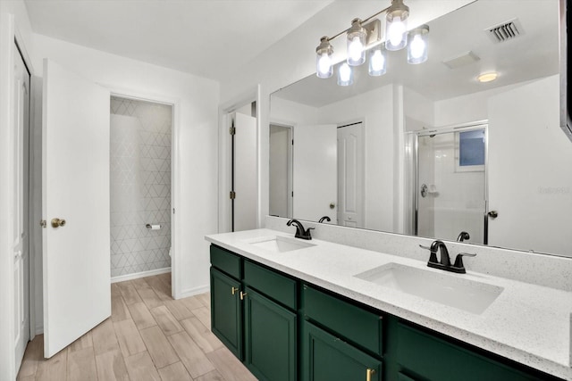 bathroom with hardwood / wood-style floors, vanity, and walk in shower