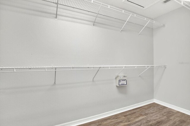 12612 Midpointe Dr, Riverview, FL 33579 - walk in closet featuring wood finished floors