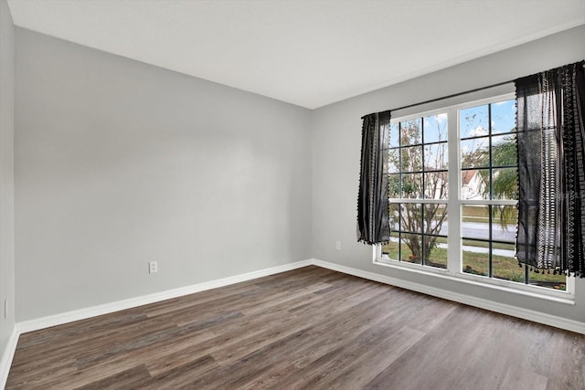 empty room with dark hardwood / wood-style floors