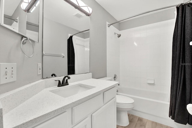 full bathroom with wood-type flooring, vanity, toilet, and shower / tub combo with curtain