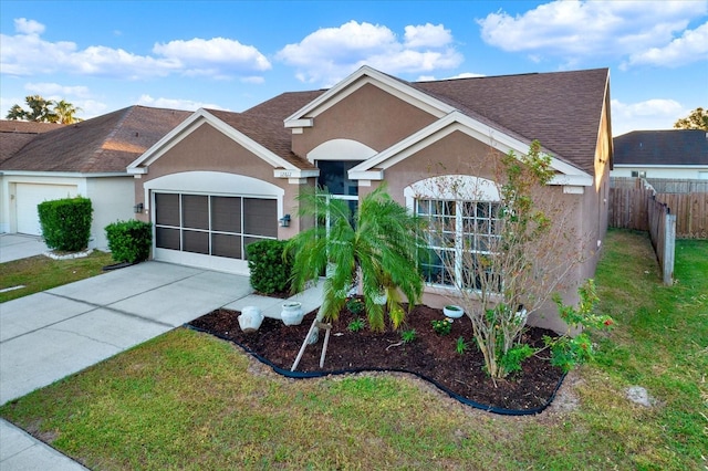 ranch-style home with a garage and a front yard