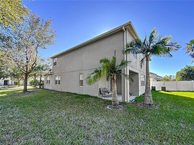 view of side of property with a yard and a patio