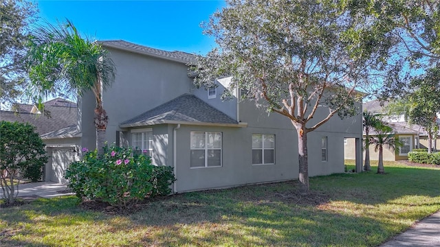 view of home's exterior featuring a garage and a yard