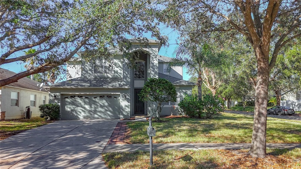 view of front of house featuring a garage and a front lawn