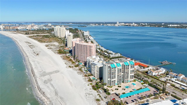 birds eye view of property featuring a water view and a beach view