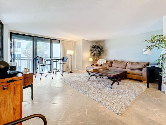 living room with expansive windows and light tile patterned floors