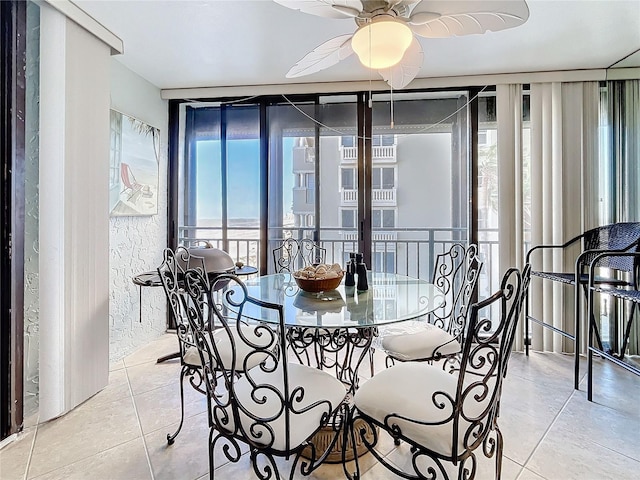 tiled dining space with ceiling fan and a wealth of natural light