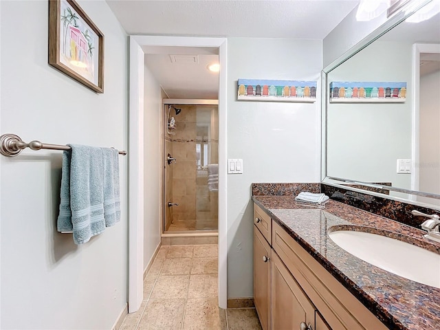 bathroom featuring tile patterned flooring, vanity, and a shower with shower door