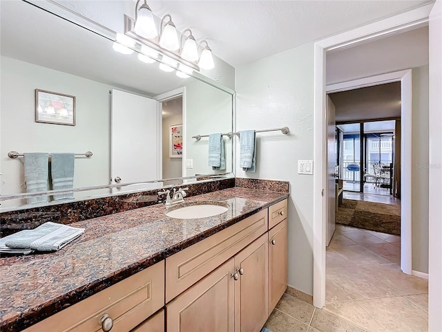 bathroom featuring tile patterned flooring and vanity