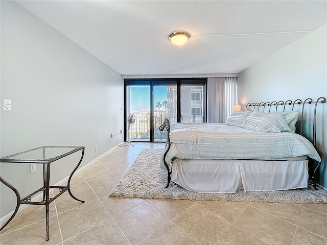 bedroom with a wall of windows and access to outside