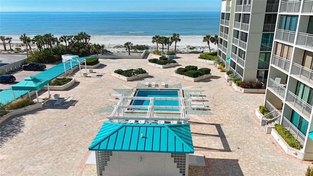 exterior space with a water view and a view of the beach