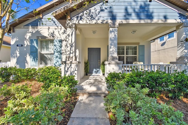 view of exterior entry with covered porch