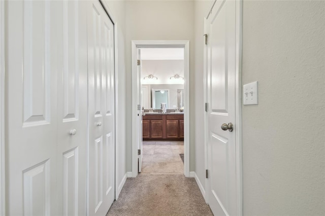 hall with light colored carpet