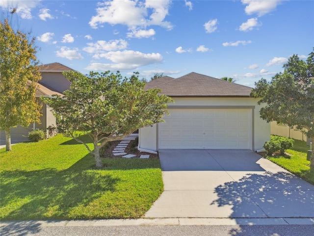 view of front of home with a front yard and a garage