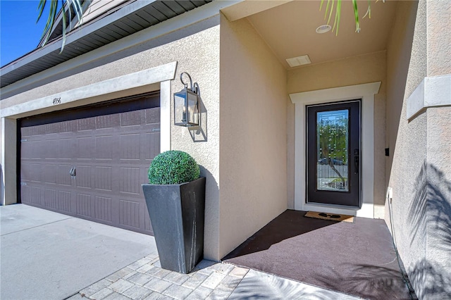 view of exterior entry with a garage