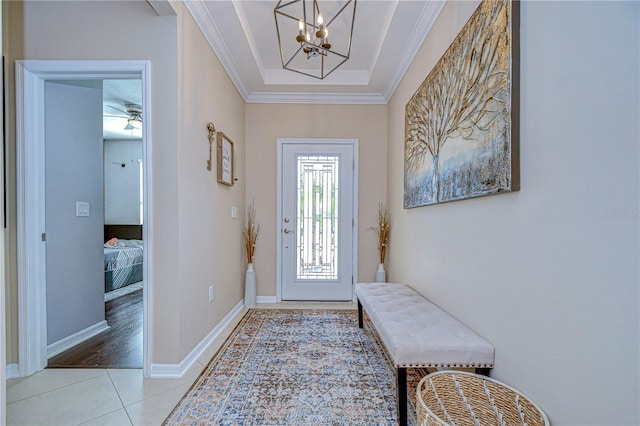 entryway featuring ceiling fan with notable chandelier, light wood-type flooring, and ornamental molding