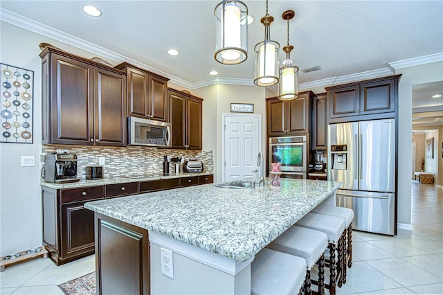 kitchen with a kitchen island with sink, sink, ornamental molding, and appliances with stainless steel finishes