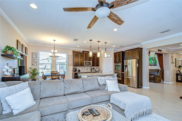 living room featuring light tile patterned floors, ceiling fan with notable chandelier, a textured ceiling, and ornamental molding