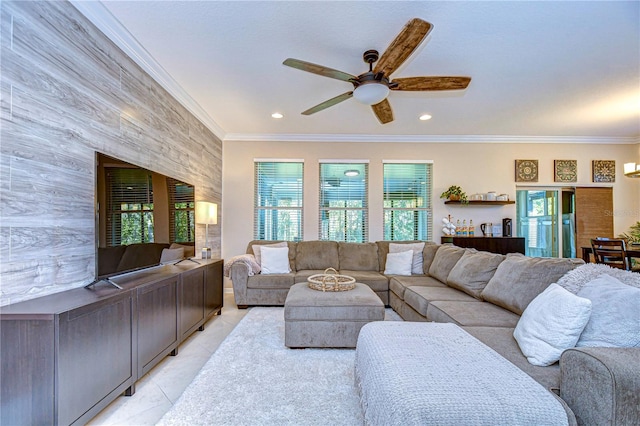 tiled living room featuring ceiling fan, a healthy amount of sunlight, and crown molding