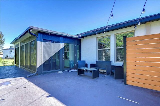 back of property featuring a patio area and a sunroom