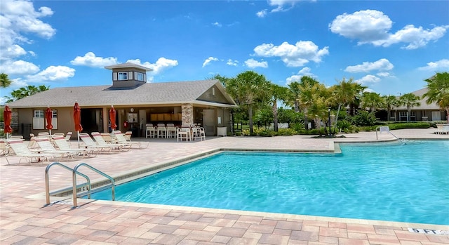 view of pool with a patio area and an outdoor bar