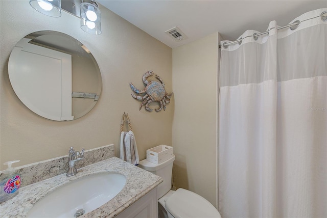 full bath featuring toilet, visible vents, and vanity