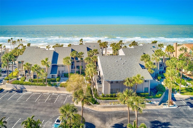 aerial view featuring a view of the beach, a residential view, and a water view