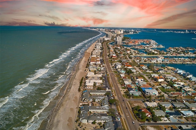 aerial view at dusk with a view of city, a water view, and a view of the beach