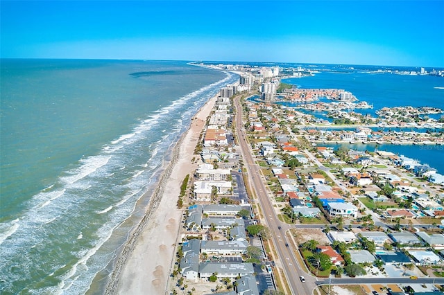 birds eye view of property featuring a water view and a beach view