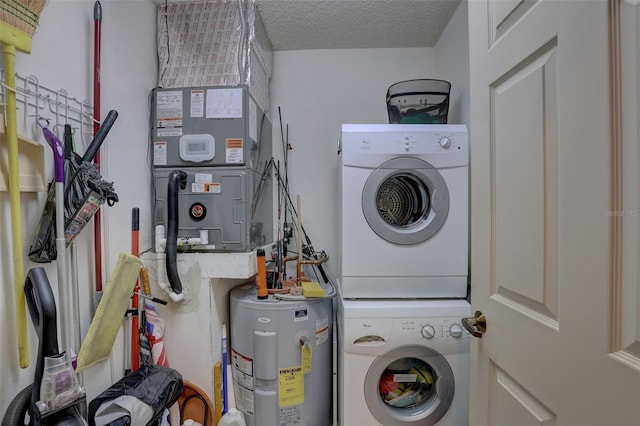 clothes washing area featuring stacked washer / dryer, electric water heater, laundry area, heating unit, and a textured ceiling