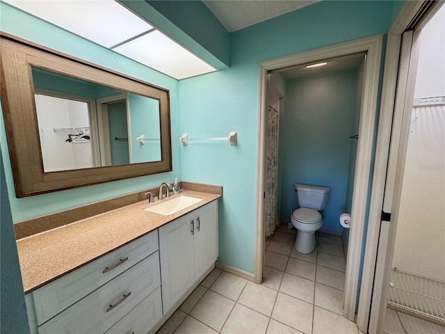 bathroom with tile patterned flooring, baseboards, toilet, a shower with curtain, and vanity