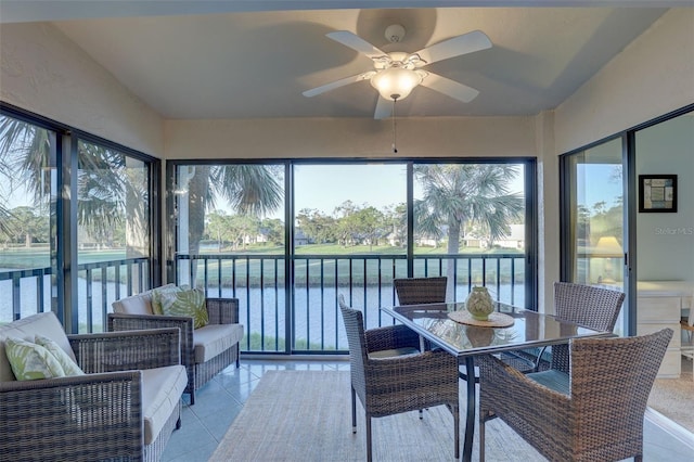 sunroom with a water view and ceiling fan