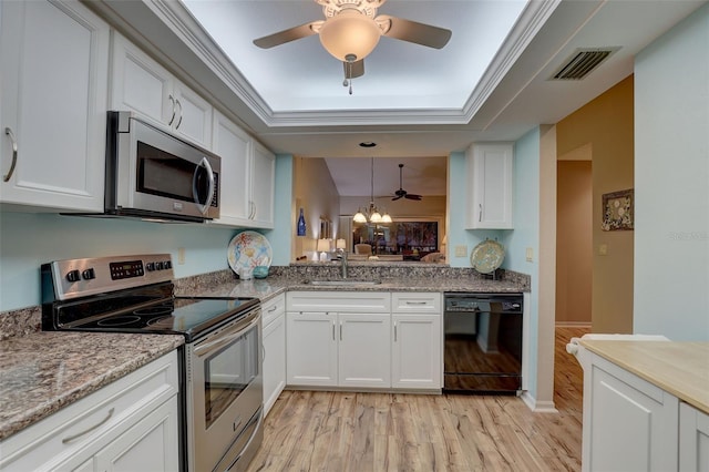 kitchen with visible vents, light wood-type flooring, stainless steel appliances, white cabinetry, and a sink