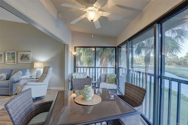 sunroom featuring lofted ceiling and ceiling fan