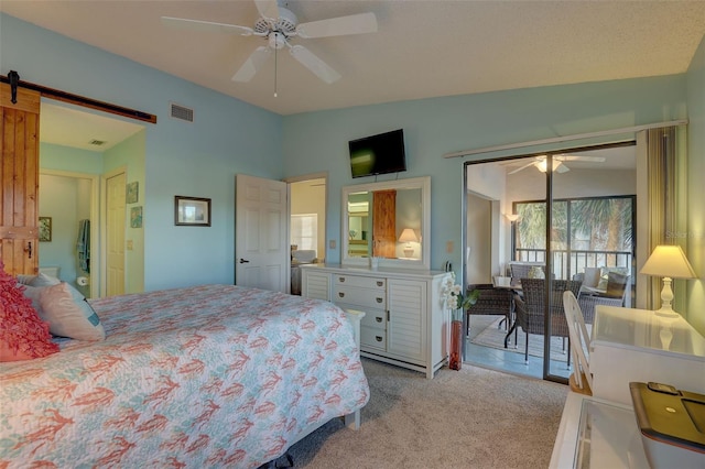 bedroom with visible vents, light carpet, access to outside, a barn door, and vaulted ceiling