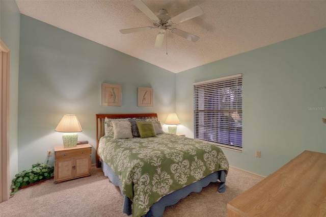 bedroom featuring lofted ceiling, a ceiling fan, carpet floors, and a textured ceiling