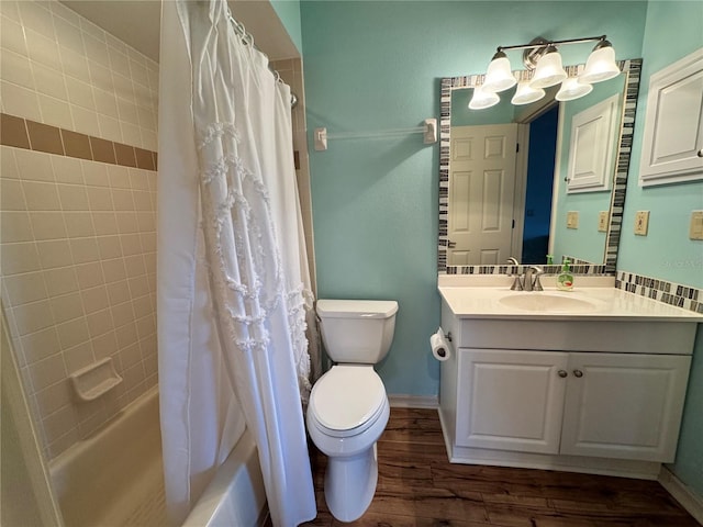 full bathroom featuring toilet, shower / tub combo with curtain, wood finished floors, baseboards, and vanity