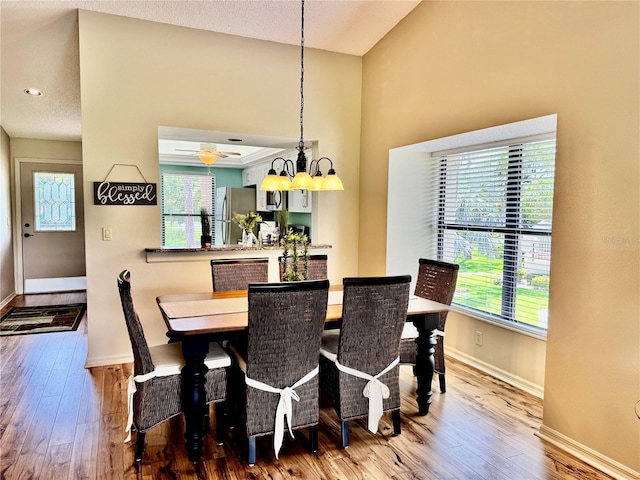 4452 Weybridge St Unit 74, Sarasota, FL 34235 - dining area featuring wood-type flooring, plenty of natural light, and a chandelier