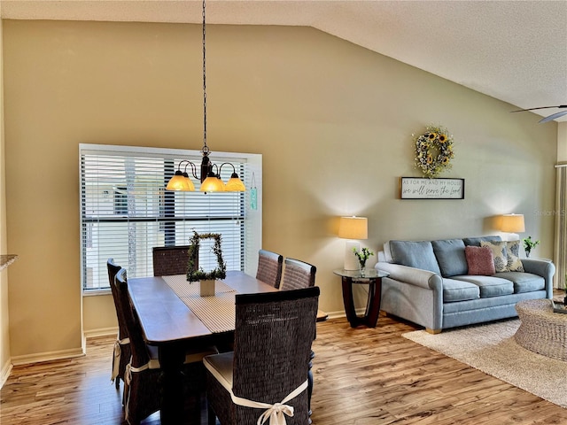 4452 Weybridge St Unit 74, Sarasota, FL 34235 - dining area with wood finished floors, lofted ceiling, and a chandelier
